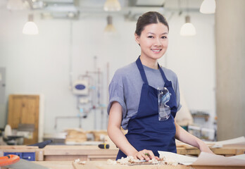 Portrait confident female carpenter in workshop