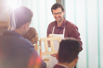 Carpentry teacher leading lesson in workshop