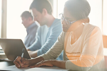 Businesswoman taking notes in meeting