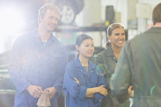 Mechanics listening in auto repair shop