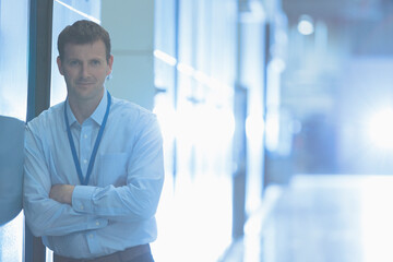 Portrait confident businessman leaning in factory