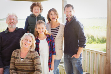 Portrait smiling multi-generation family on sunny porch