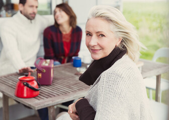 Portrait smiling senior woman at patio table
