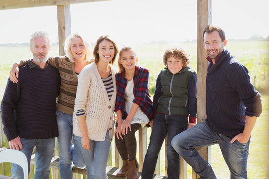 Portrait smiling multi-generation family on sunny porch