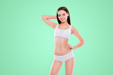 Fototapeta na wymiar Portrait of fit slender woman with perfect body in white cotton underwear bikini posing looking at camera isolated on white background