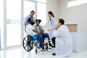 Fototapeta premium Doctor caring for a patient with a broken leg sitting in a wheelchair.