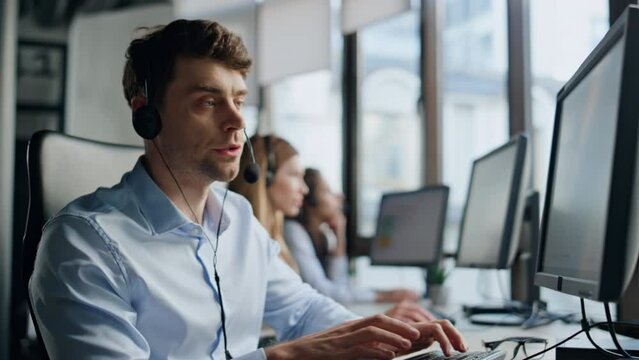 Technical support talk client in office. Pensive man specialist typing computer