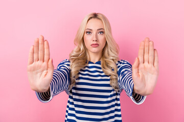 Photo of confident adorable woman with wavy hairdo dressed striped shirt palms showing stop...