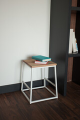 Shabby wooden table with chairs and vase located near comfortable couch against light walls with decorations in modern apartment. High quality photo