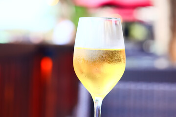 white wine tasting, chilled ice wine in a cold glass in summer