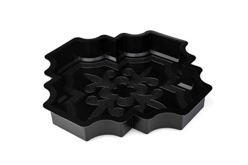 Black plastic molds for making paving slabs on a white background.