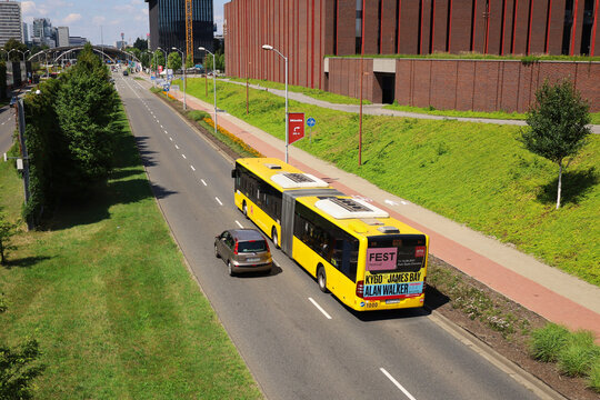 KATOWICE, POLAND - JULY 29, 2021: Public bus Mercedes O530 Citaro G, line number 673 follows its route in the area Katowice Cultural Zone near NOSPR. Top view from the footbridge over the alley.