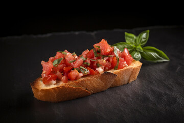 Tomato Toast with Basil (Italian Bruschetta), dark black background