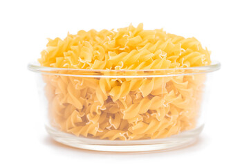 Uncooked Fusilli Pasta in Glass Jar Isolated on White Background. Fat and Unhealthy Food. Classic Dry Spiral Macaroni. Italian Culture and Cuisine. Raw Pasta