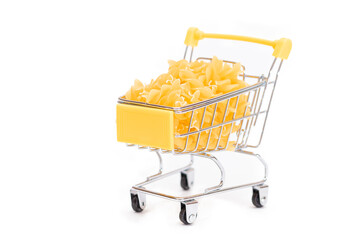 Uncooked Fusilli Pasta in Small Shopping Cart Isolated on White Background. A Crisis: Buying Cheap Food. Classic Dry Spiral Macaroni. Italian Culture and Cuisine. Raw Pasta - Isolation