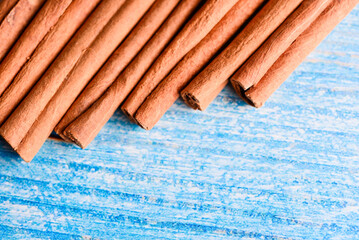 Orange cinnamon sticks with sun lights on the kitchen table.