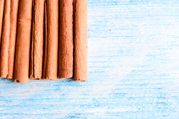 Orange cinnamon sticks with sun lights on the kitchen table.