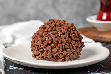 Chocolate cake. Mole cake with chocolate chips on dark background. Close up