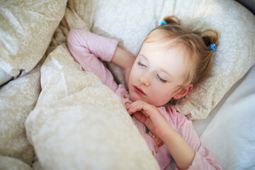 Little child sleeping in bed