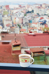 Cup of black Turkish coffee with view to the roofs of Uskudar district on Asian side of Istanbul, Turkey