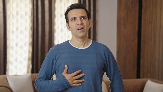 Indian man having acidity problem after eating