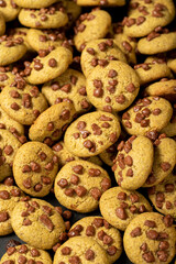 Chocolate cookie. Homemade chocolate chip cookies on a dark background. Pile cookies background. food background. Close up