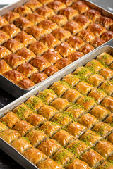 Turkish baklava. Pistachio and walnut baklava on a dark background. Turkish cuisine delicacies. Close up