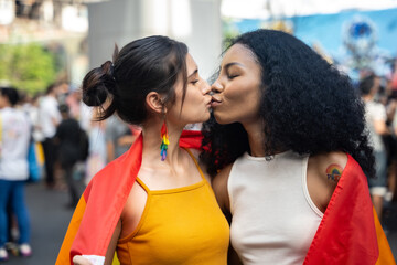 Portrait of Happy loving homosexual lesbian LGBT couple kissing at city streets. LGBT and Pride...