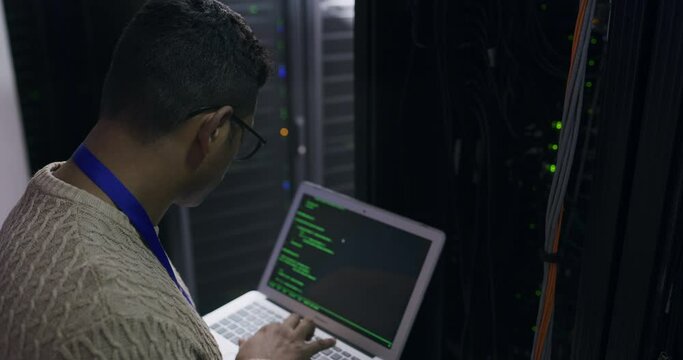 Man in server room with laptop, coding and network administration, engineer in digital storage for cyber security. Tech employee, system maintenance and technician online in datacenter for ssl update