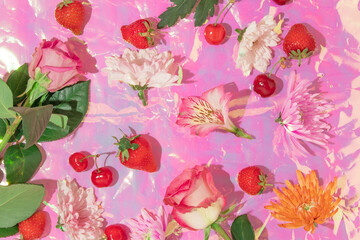 Summer creative background with strawberries, cherries and flowers on iridescent  pastel colors...