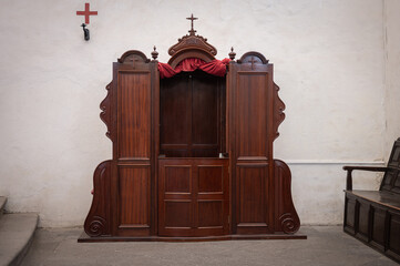 Detail of an old wooden confessional in a Spanish church, in Las Palmas de Gran Canaria - obrazy, fototapety, plakaty