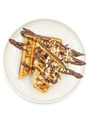  Belgian waffles with chocolate paste and nuts. Isolate, top view.