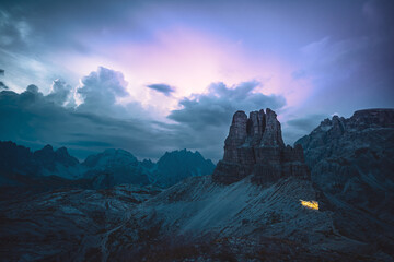 Fototapeta na wymiar Head tourch trails of mountaineers hiking on dolomite hiking trails with a thunder storm in the background. Tre Cime, Dolomites, South Tirol, Italy, Europe.