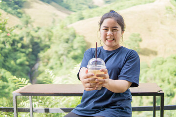 Thai woman drinking coffee outdoors