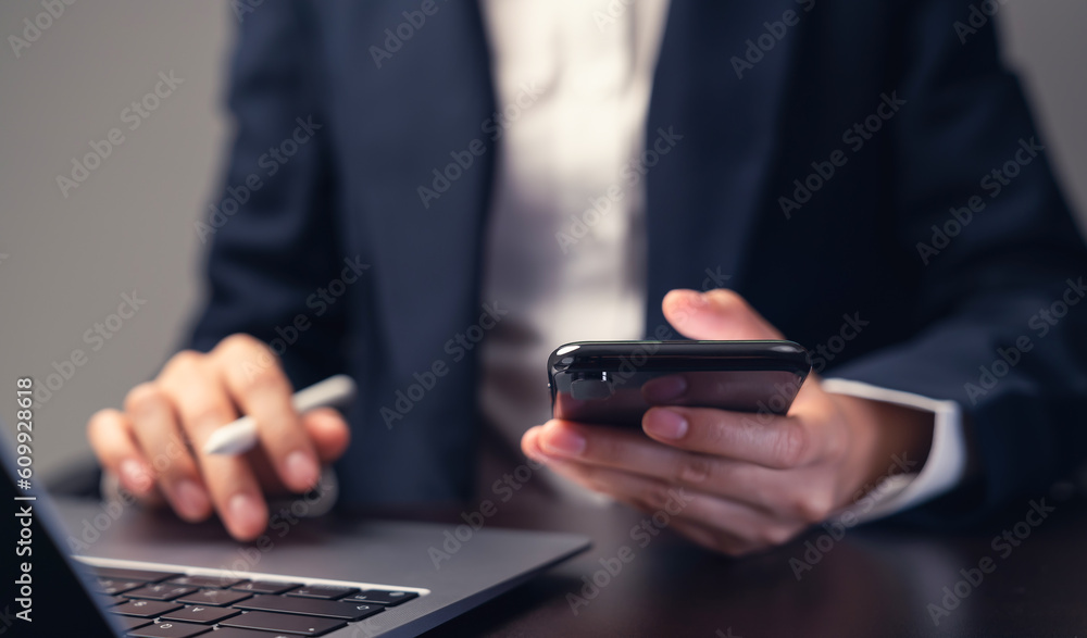 Aufkleber businessman using smartphone and hand typing on the computer keyboard in the office.