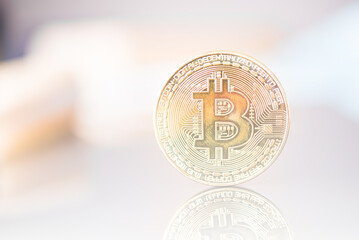Golden Bitcoin on light background. Close-up, macro shot. Virtual Money