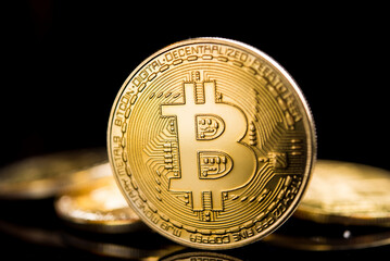 Bitcoin. Crypto currency Gold Bitcoin, BTC, Bit Coin. Macro shot of Bitcoin coins isolated on black background.