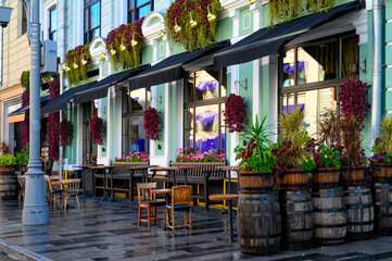 Street with tables of pub in center of Moscow in Russia. Cozy cityscape in Moscow. Architecture and landmarks of Moscow.