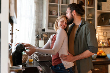 Lovely multiethnic couple spends quality time together smiling at home. People happiness concept.