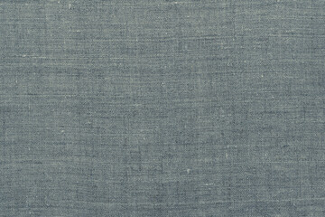 Fototapeta na wymiar Natural gray linen background or texture, top view, close-up