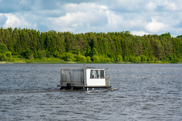 Small catamaran sailing with a passengers on the lake