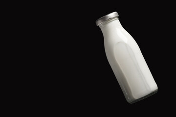 Milk bottle on black background, top view. - 609942867