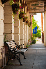 bench into the sidewalk of historic Orth buiding of Jacksonville, Oregon - focus on foreground