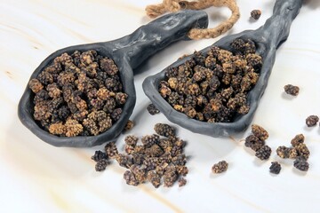 dried black mulberry fruit, Heap of dried black mulberry isolated on white