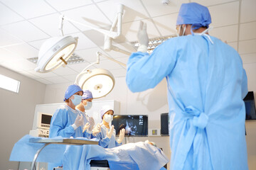 Medical team with patients inside emergency room.