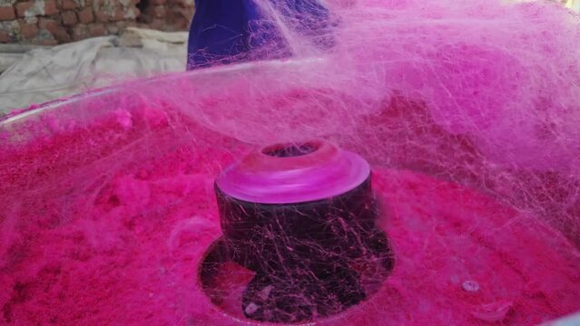 Closeup of a machine creating layers of cotton candy or candy floss