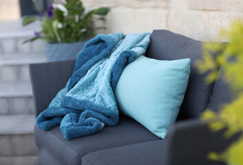 Knitted Throw, gray sofa in the courtyard of the home garden
