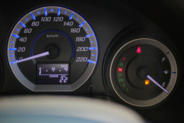 Driving car with digital oil gasoline level sign on the panel dashboard indicates that oil fuel is...