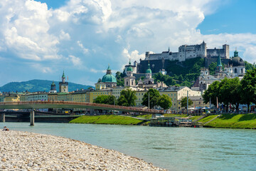 Salzach riverbank in Austria Salzburg with towers and the castle skyline of the city
