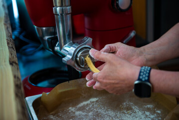 Dough for churros being drawn from a kitchen machine